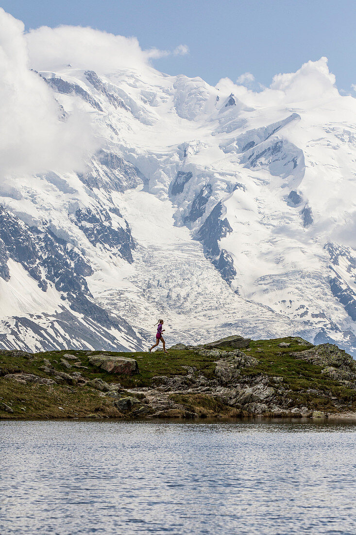 Girl trail running in Chamonix around the Chesery lake