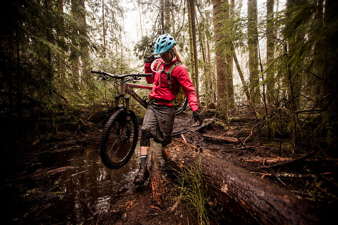 A female mountain biker on a rainy, snowy day in Issaquah, Washington.