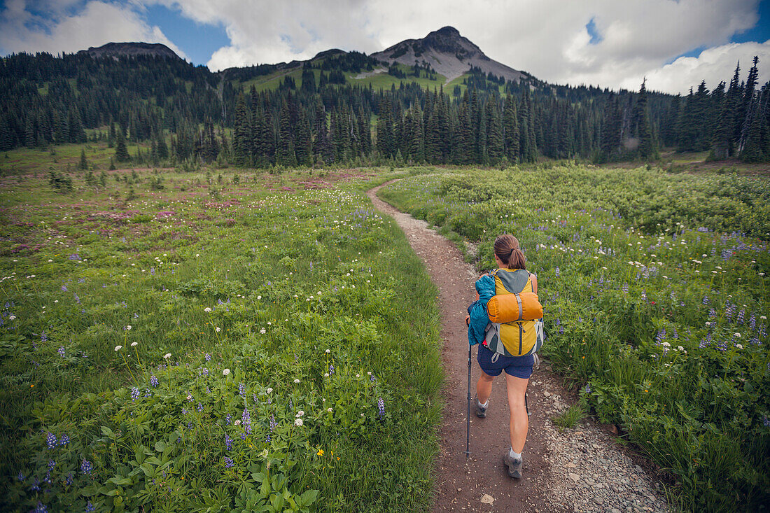 A young woman hiking through Taylor Meadows in Garibaldi Provincial Park, British Columbia, Canada.