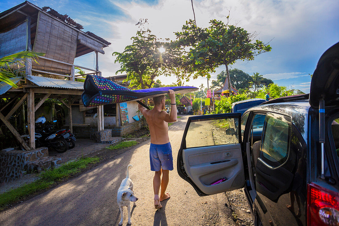 Surfer with a board at morning time