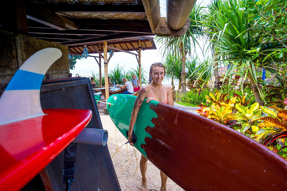 Young woman with surfboard.