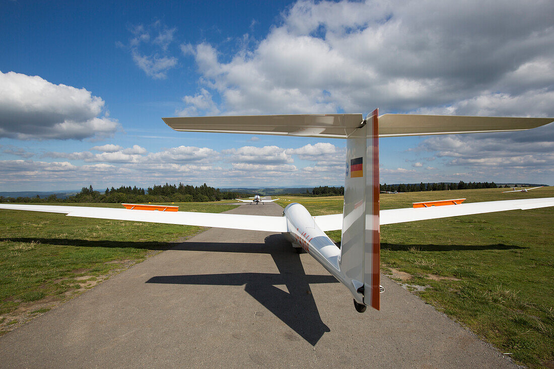 Glider airplane is launched by tow airplane at Flugplatz Wasserkuppe air field