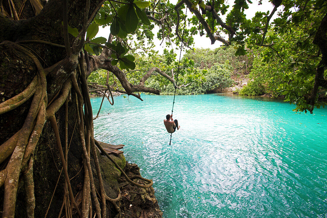 Visitor takes the plunge at the Blue Lagoon on the island of Efate