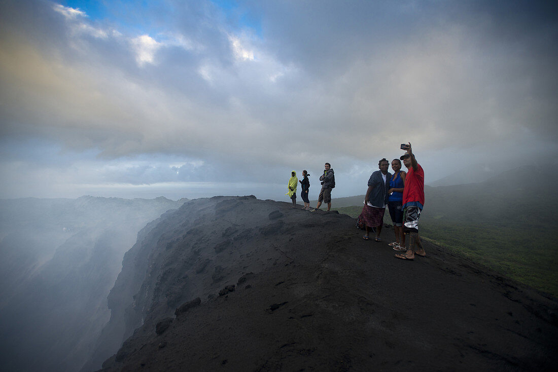 On the rim of the crater of the active volcano Yasur on the island of Tanna