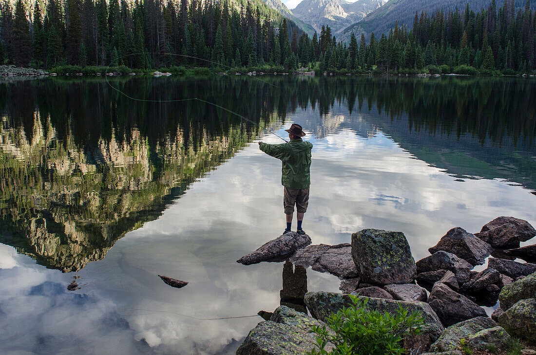 Photographer Jeremy Wade Shockley casts his fly line accross Emerald Lake, Weminuche Wilderness, Southwest Colorado.