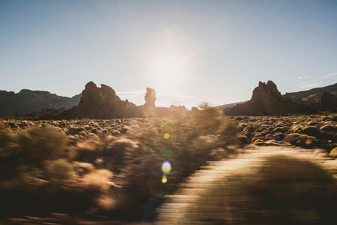 Blurred view of a mountain landscape at sunset
