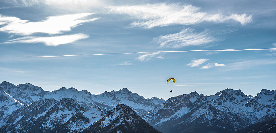 Overlooking the mountains of the German Alps with paragliders in the sky, Oberstdorf, Allgaeu, Germany