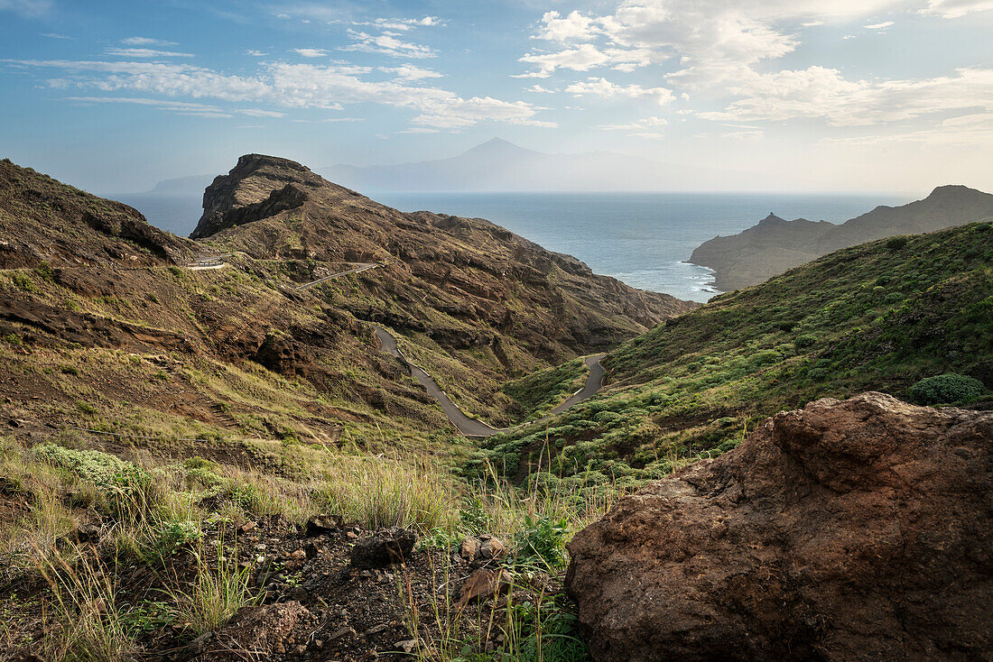 coastal road leading to the beach between Hermigua and Agulo, view towards Teide volcano, La Gomera, Canary Islands, Spain