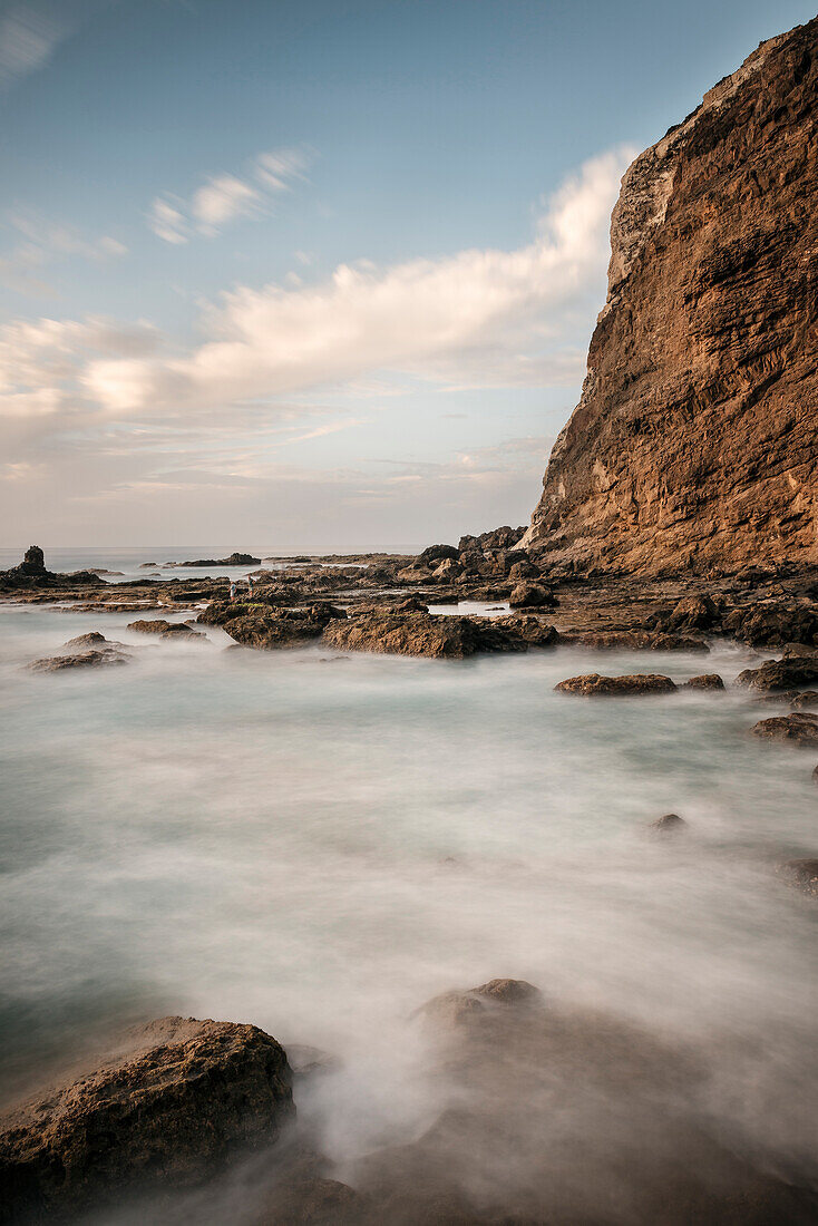rough sea hitting the coast of rocky bay Playa de Alojera, La Gomera, Canary Islands, Spain, long time exposure