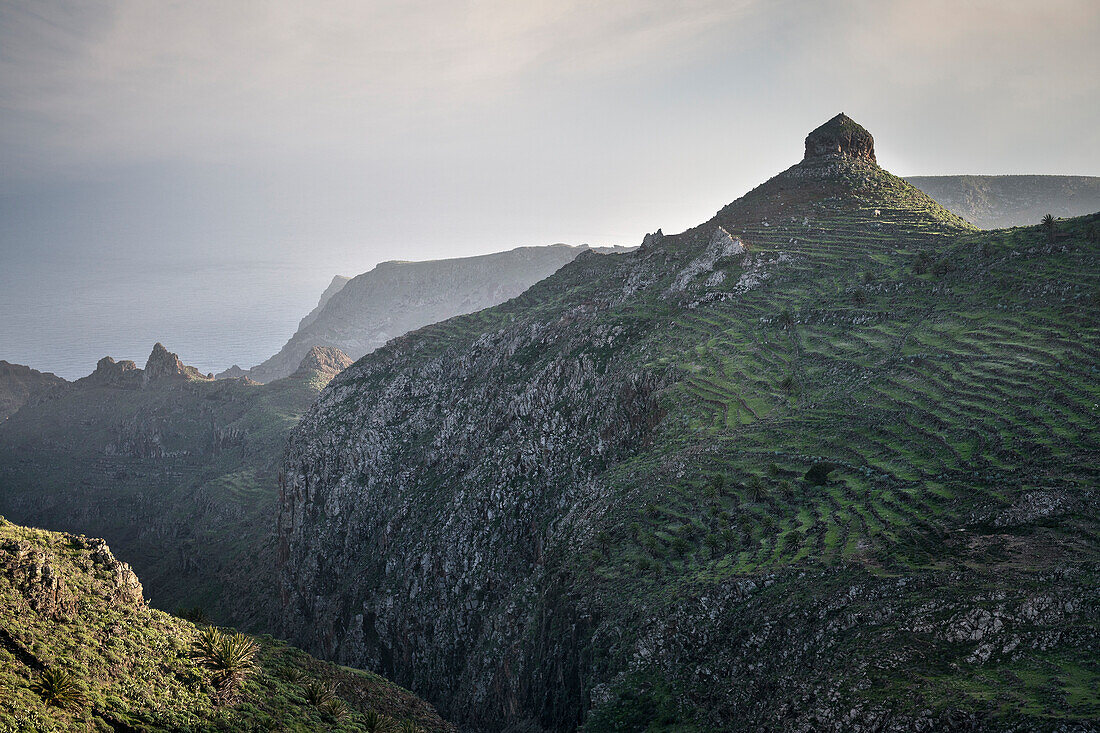 prominent rock formation and trails in the mountaineous landscape around National Park Parque Nacional de Garajonay, La Gomera, Canary Islands, Spain