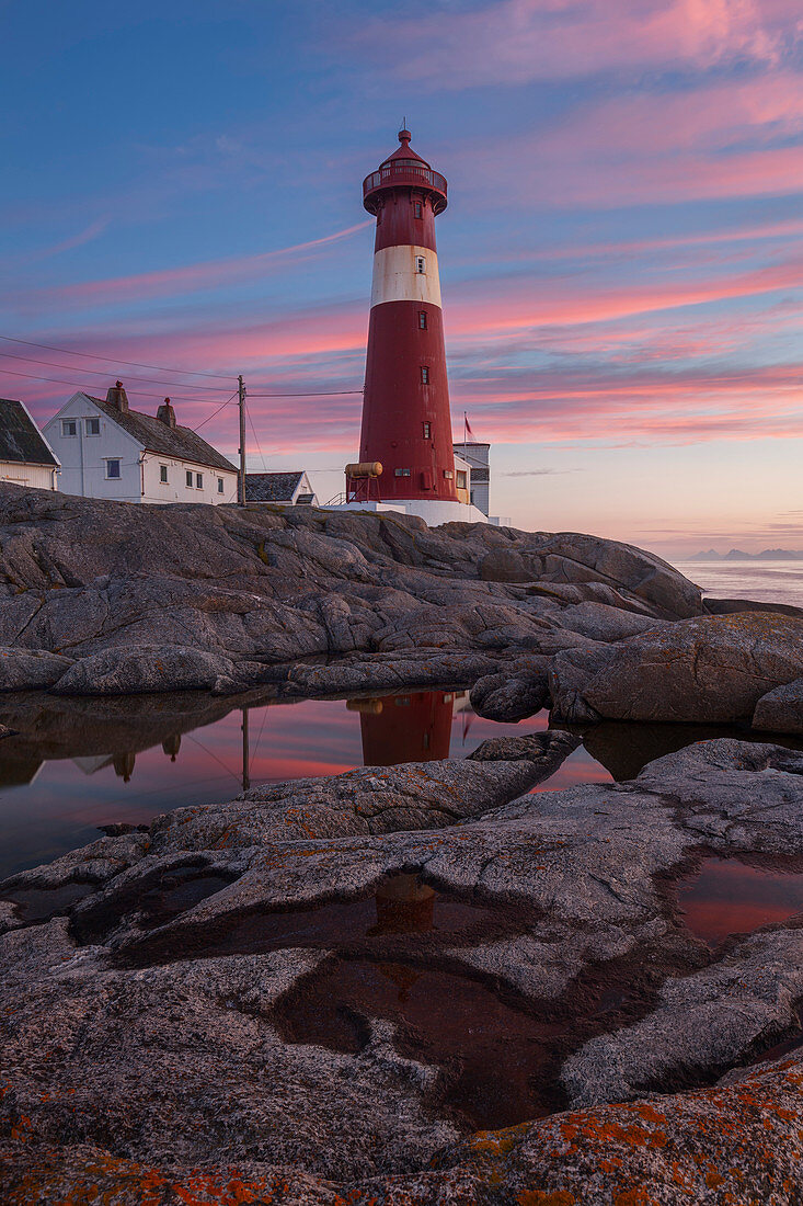 Picturesque sunset above the lighthouse Tranøy Fyr in summer with it's reflection, Tranøya, Hamarøy, Nordland, Norway, Scandinavia
