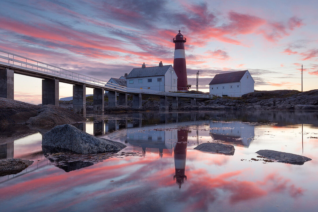 Picturesque sunset above the lighthouse Tranøy Fyr in summer with it's reflection in the ocean, Tranøya, Hamarøy, Nordland, Norway, Scandinavia