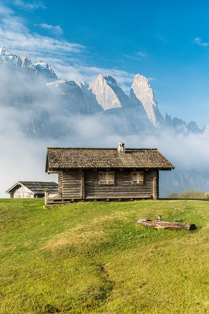 Passo Gardena, Dolomites, South Tyrol, Italy. Mountain hut in front of the mountains of the Sella group