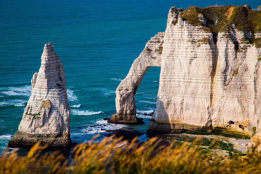 Etretat, Normandy, France. The cliffs over the Atlantic Ocean during a sunny day.