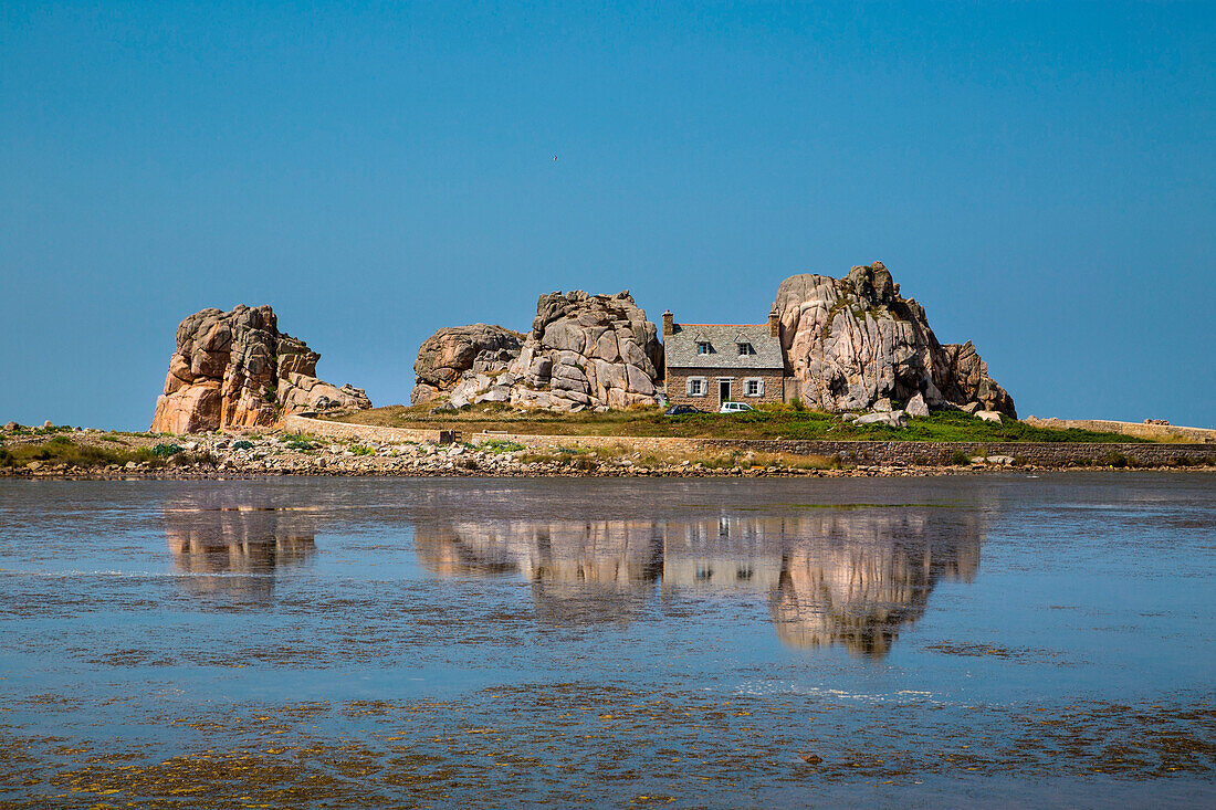 Bretagne, France. The famous house surrounded by rocks, reflecting itself in the sea.