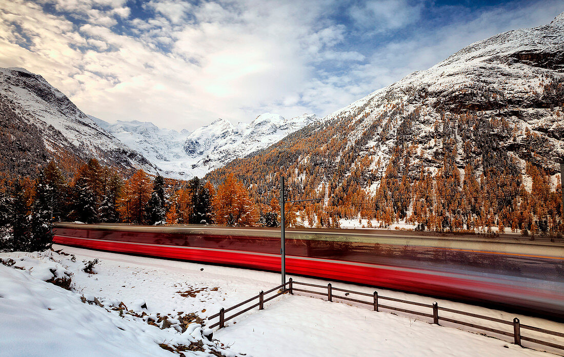 Bernina Express making its journey through the Swiss Alps, Engadine, Switzerland