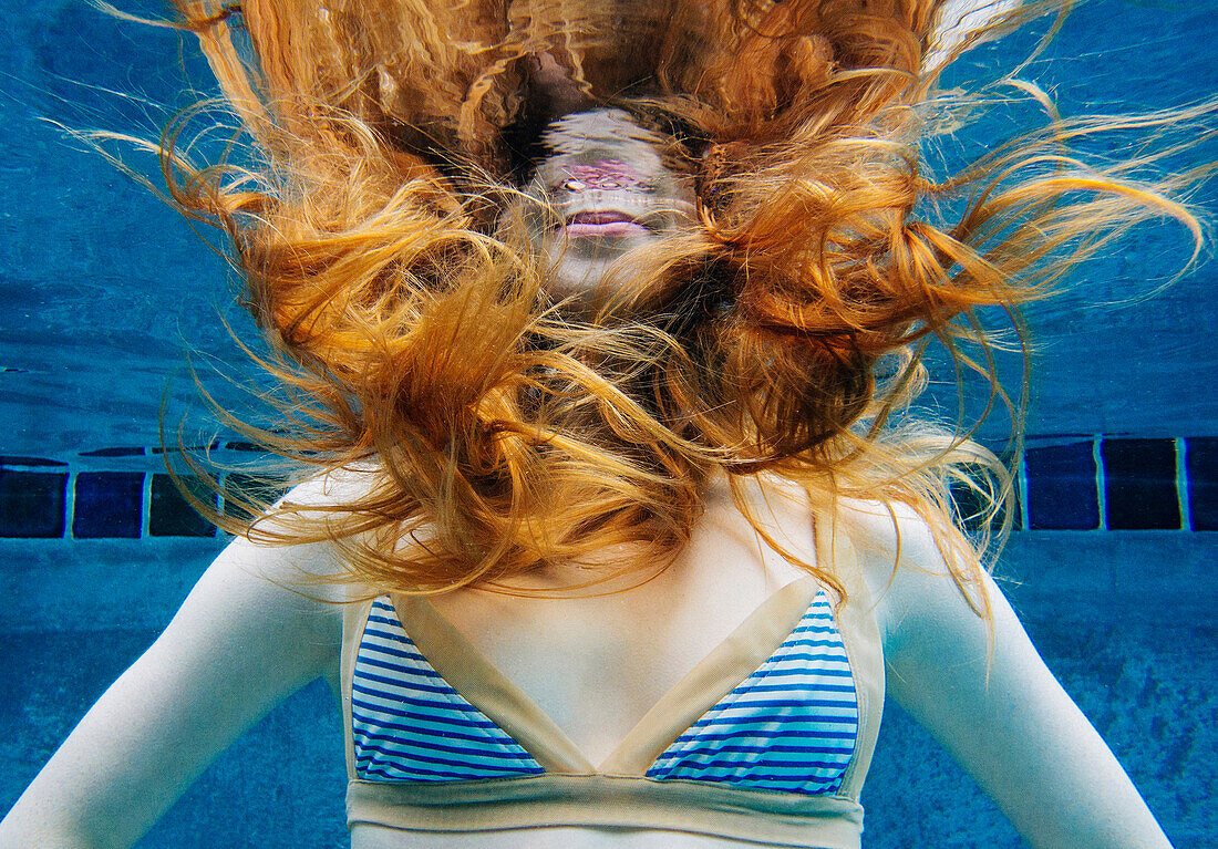 Caucasian woman underwater in swimming pool