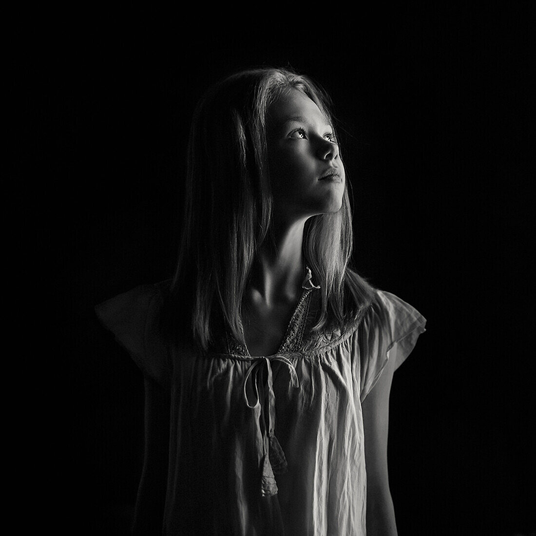 Caucasian teenage girl looking up