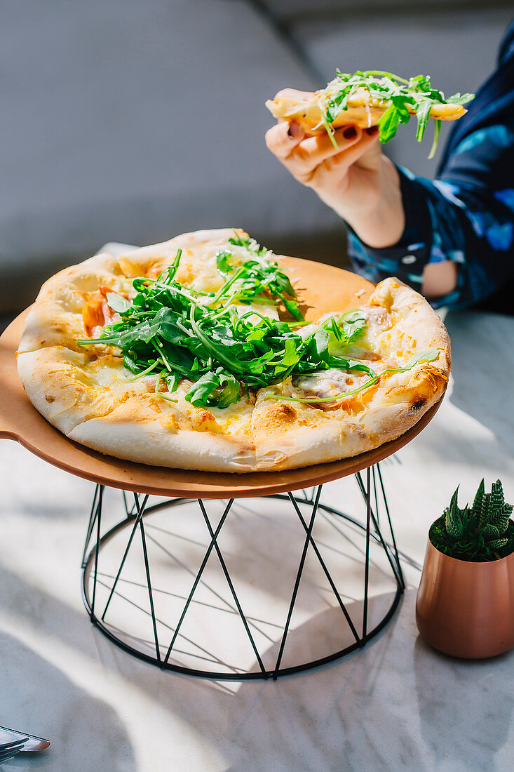 Caucasian woman eating pizza in cafe