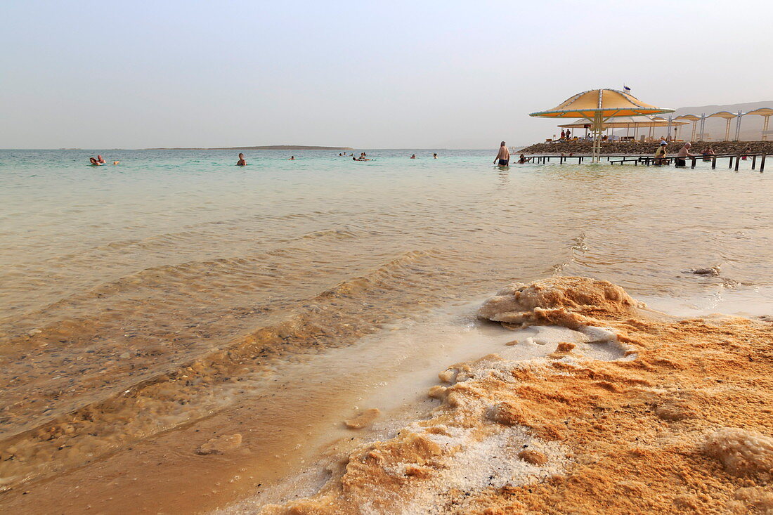 Bathers in the Dead Sea, with salty shoreline, Ein Bokek (En Boqeq) beach, Israel, Middle East