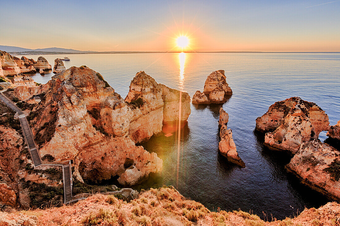 Golden sunrise on the red cliffs of Ponta Da Piedade, Lagos, Algarve, Portugal, Europe