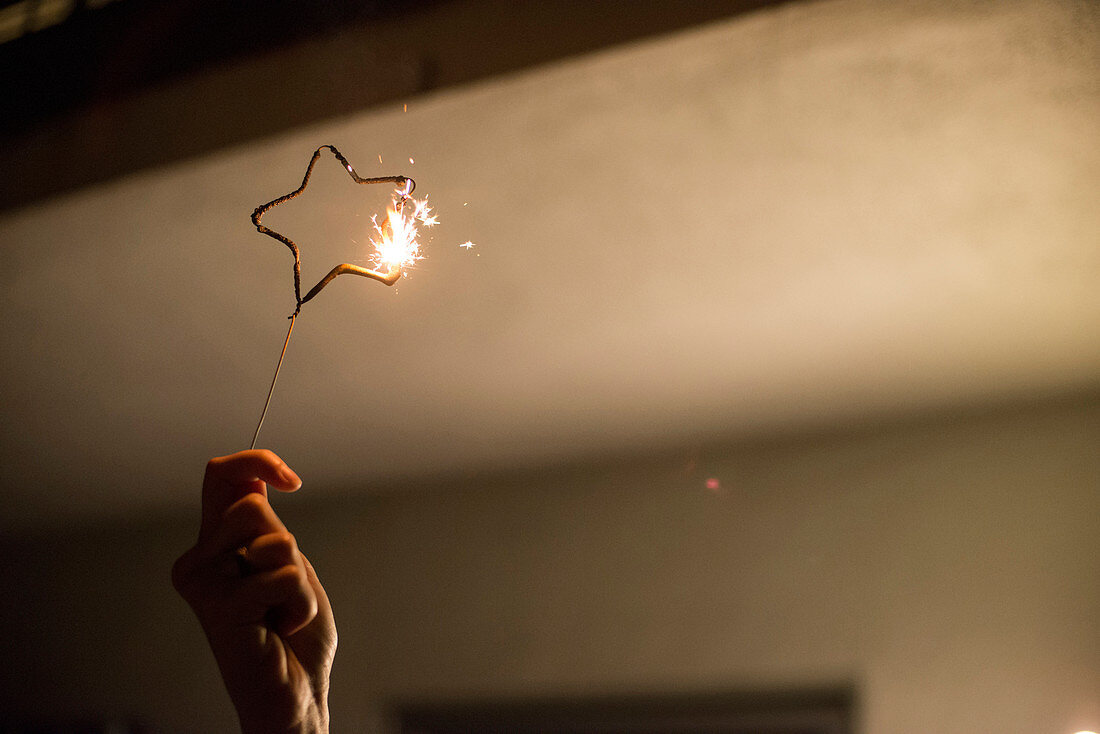 A woman's hand holds up a star-shaped sparkler while celebrating the Fourth of July on July 4, 2014, in Venice, Calif.