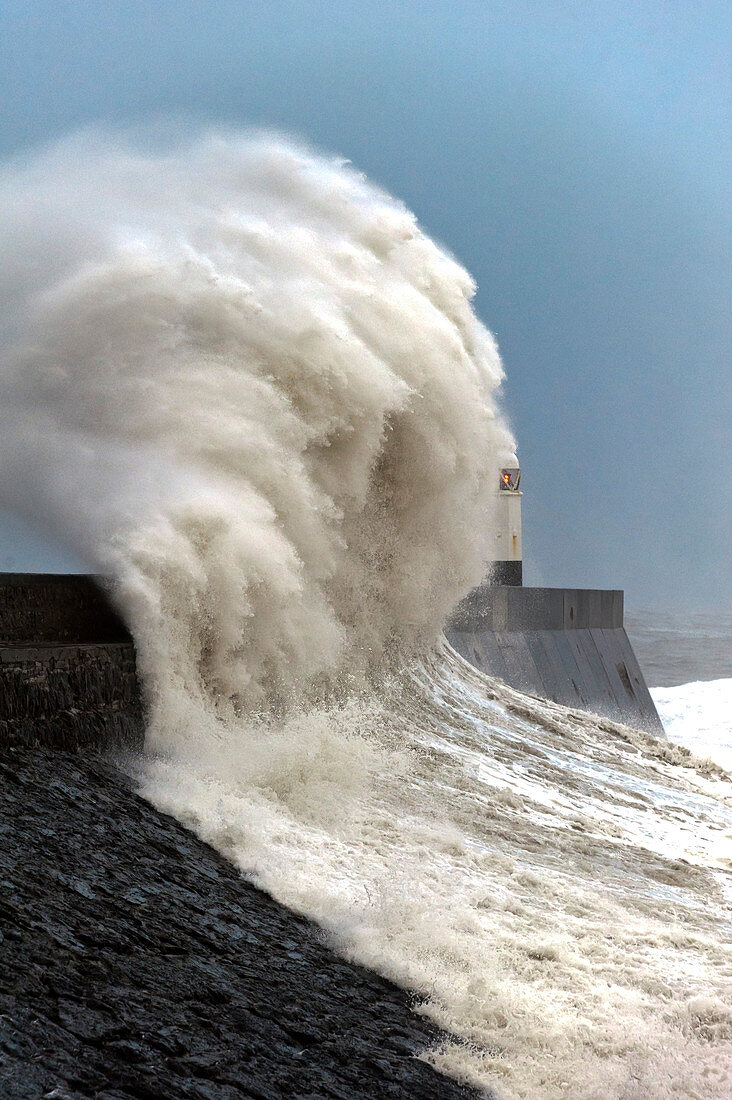 Huge waves crash against the harbour wall at Porthcawl, Bridgend, Wales, United Kingdom, Europe