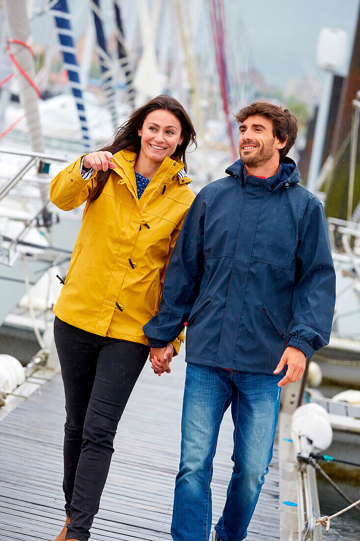 Couple walking. Rain. Marina. Hendaye. Aquitaine. France.