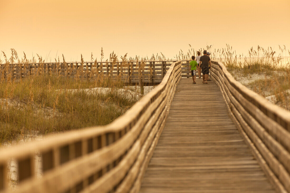 A scenic view of a boardwalk thru the sand dunes at the Gulf Coast State Park´s white sand beach, in Orange Beach, Alabama