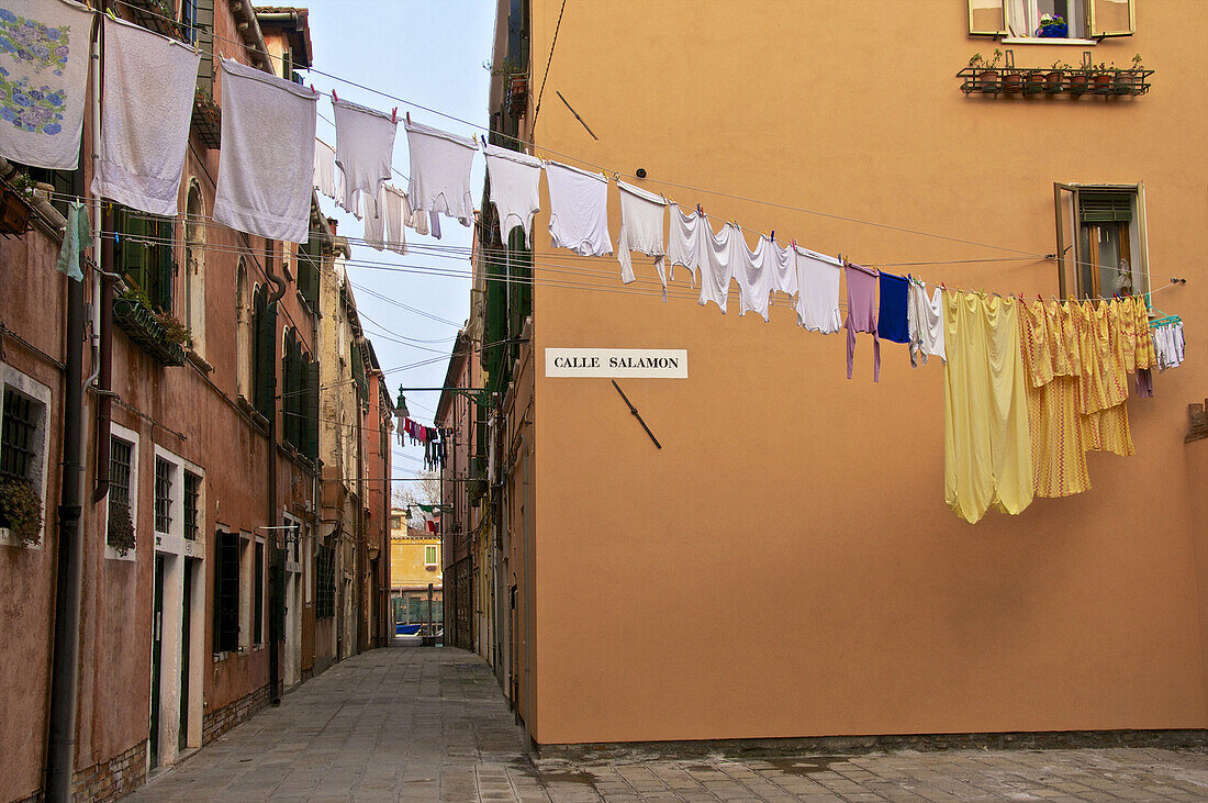 hanging lines of drying washing, across the street, Venice, Italy.