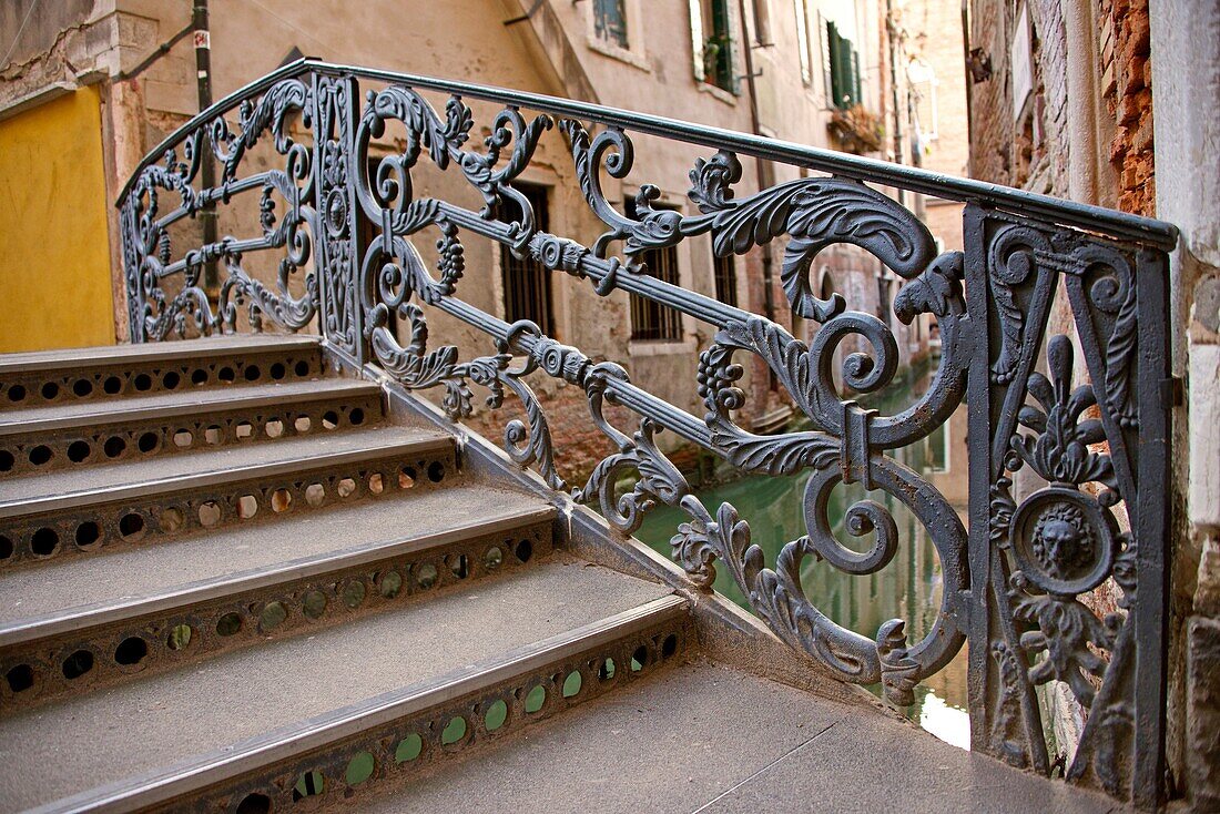 a metal bridge over a canal, Venice, Venetia, Italy.