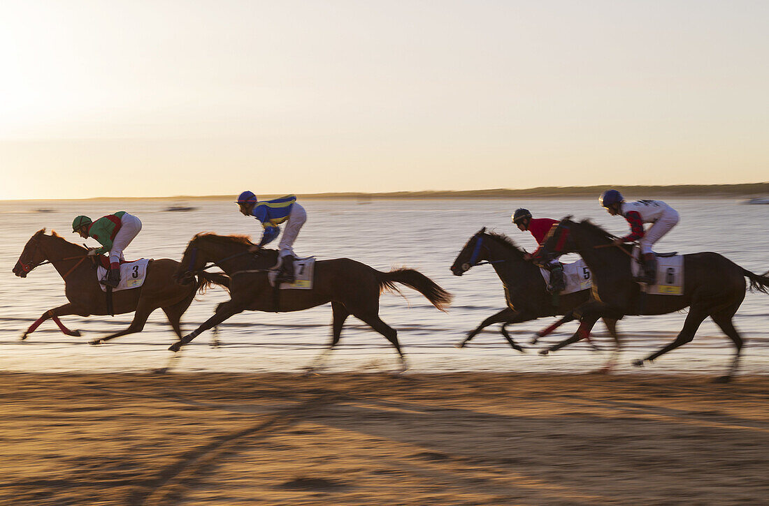 Shortly before sunset at the famous horse races of Sanlúcar de Barrameda which take place every year during August along a 1.800m stretch of beach at the mouth of the River Guadalquivir. This tradition dates back to 1845. On the opposite river bank the fa