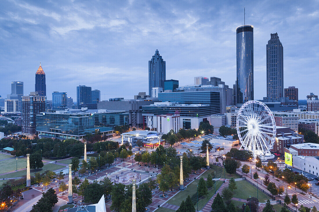 USA, Georgia, Atlanta, Centenial Olympic Park, elevated city view with ferris wheel, dusk.
