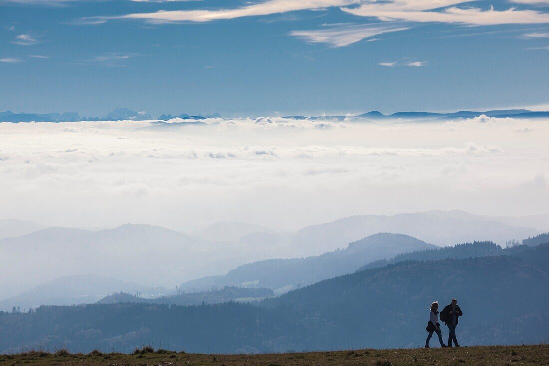 Germany, Baden-Wurttemburg, Black Forest, Belchen Mountain, summit view towards the Alps with people.