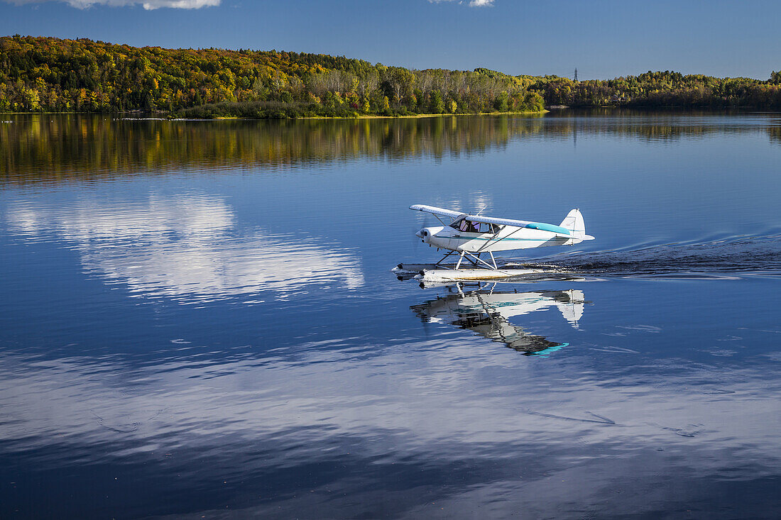 A seaplane landing on the Saint-Maurice River in Shawinigan, Quebec, Canada.