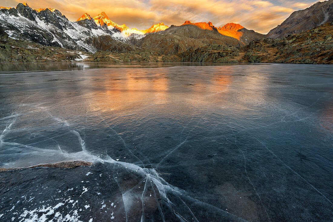 Italy, Trentino Alto Adige, Adamello Brenta Park, Nambrone valley, Dawn at Black Lake, in background Presanella group sunlit.