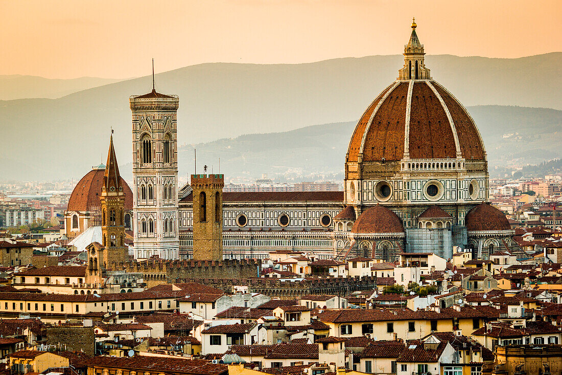 Florence, Tuscany, Italy. cityscape and Cathedral and Brunelleschi Dome, Giotto Tower. Sunset, lights on.