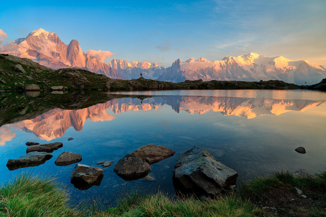 m.blanc and an hiker mirrored on lake of Cheserys, chamonix, france, europe