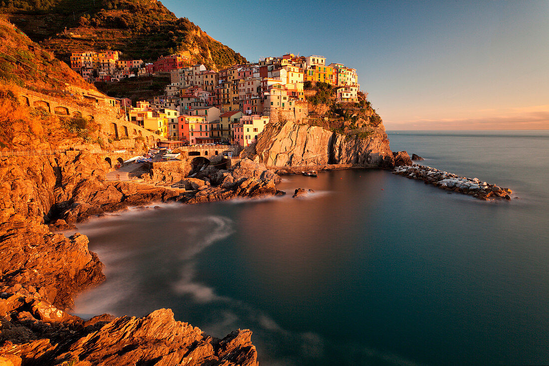 Manarola, Cinque Terre, Liguria, Italy. Manarola, one of the Five Lands villages, is illuminated by the last sunrays