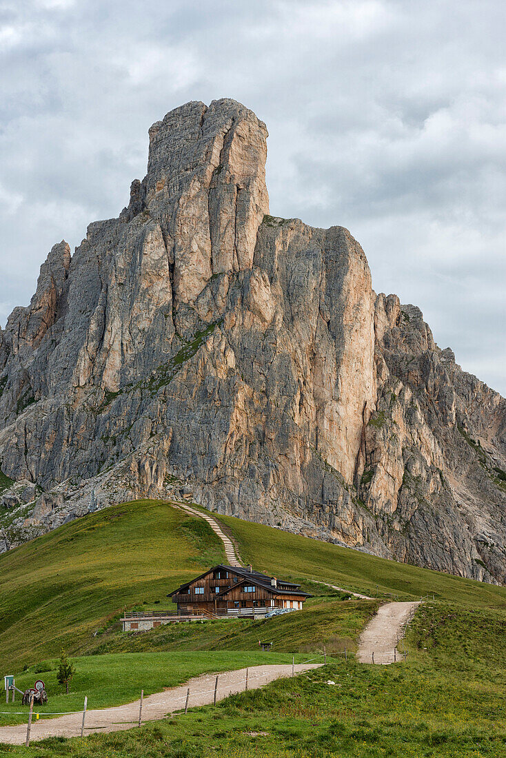 Mountain hut and mount Gusela in a cloudy day on Summer, Giau Pass, Dolomites, Veneto, Italy