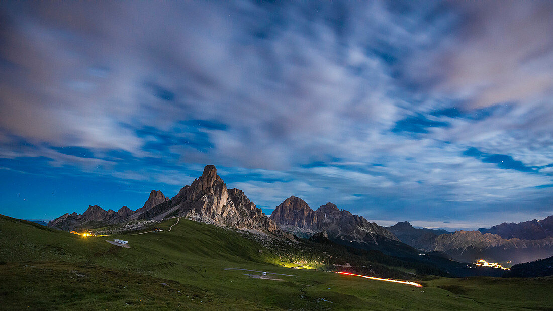 Gusela mountain in a starry night with clouds, Giau pass, Dolomites, Veneto, Italy