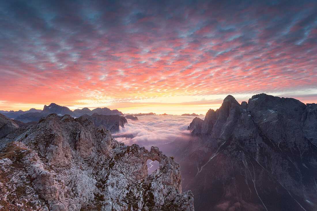 The heart shaped arch of stone in the Pale of the Balconies, Pala group, Dolomites. Europe, Italy, Veneto, Agordino, Belluno