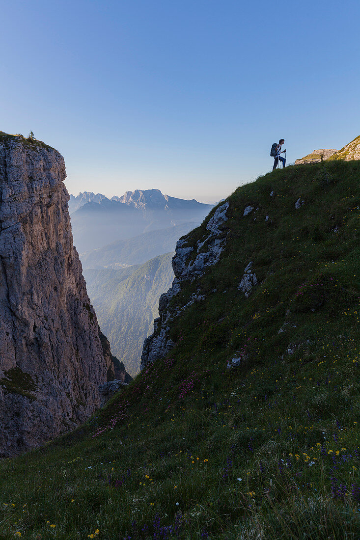 Hiker in silhouette near fork Besausega, Dolomites, Pale di San Lucano, Agordino, Belluno, Veneto, Italy, Europe