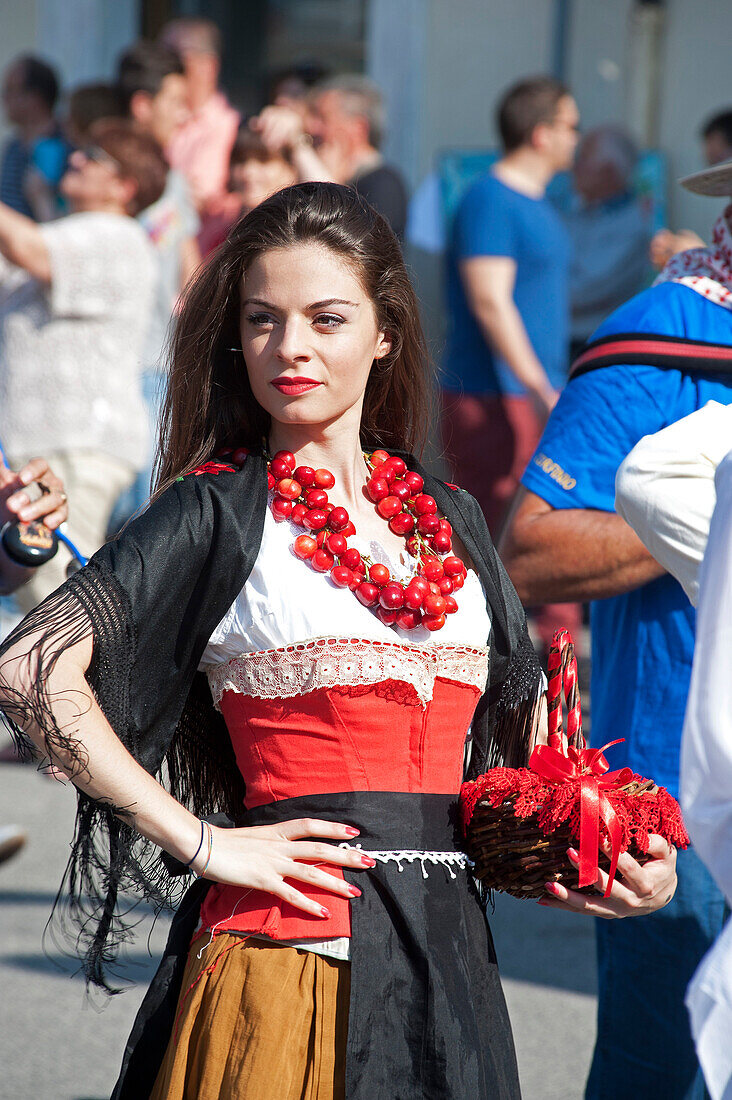 A woman decorated with cherries at the cherry festival in Raiano