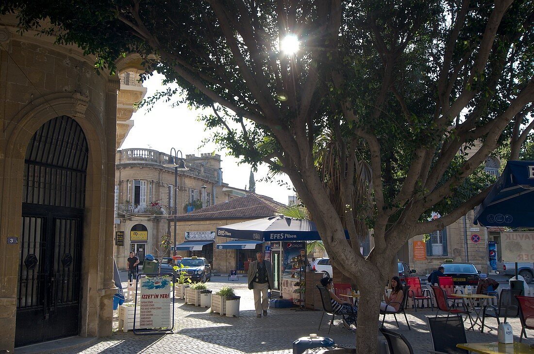 Square at the Dikili Tas, coffee tables under trees,  monument ,  Lefkosa, Nicosia, North Cyprus