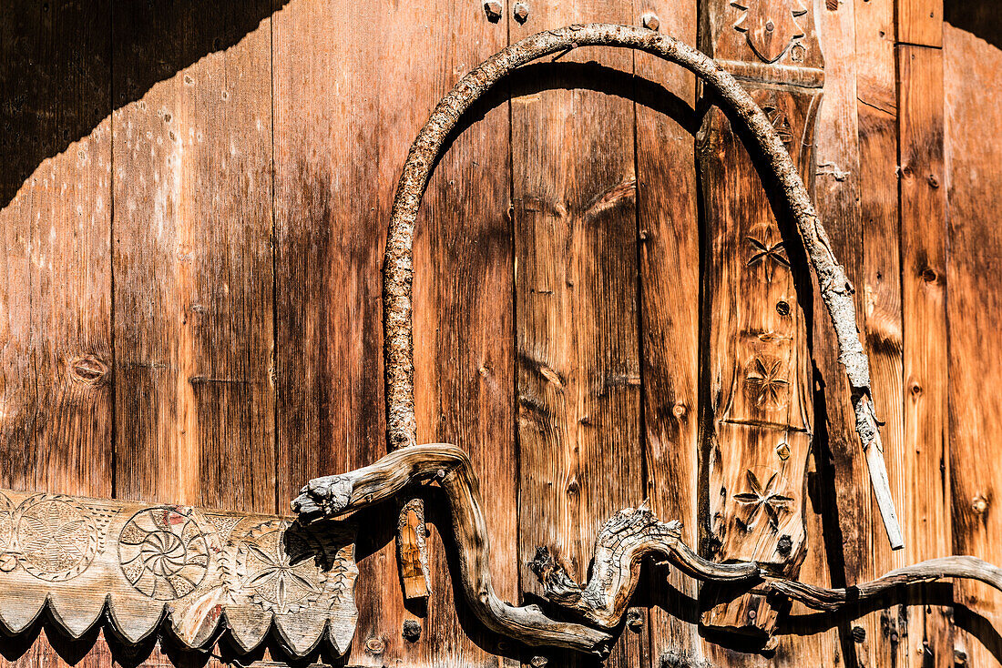 A wooden hut in the Alps, decorated with carvings and wooden stick look like a snake, Santa Maria im Münsterland, the Grisons, Switzerland