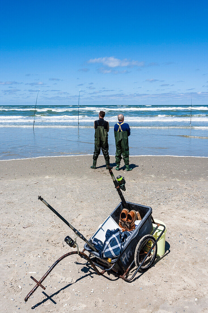 Two anglers on the beach wait for the big catch out of the North Sea, Juist, Schleswig Holstein, Germany