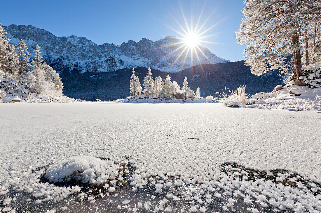 View over the frozen Eibsee to the Zugspitz range, near Grainau, Bavaria, Germany