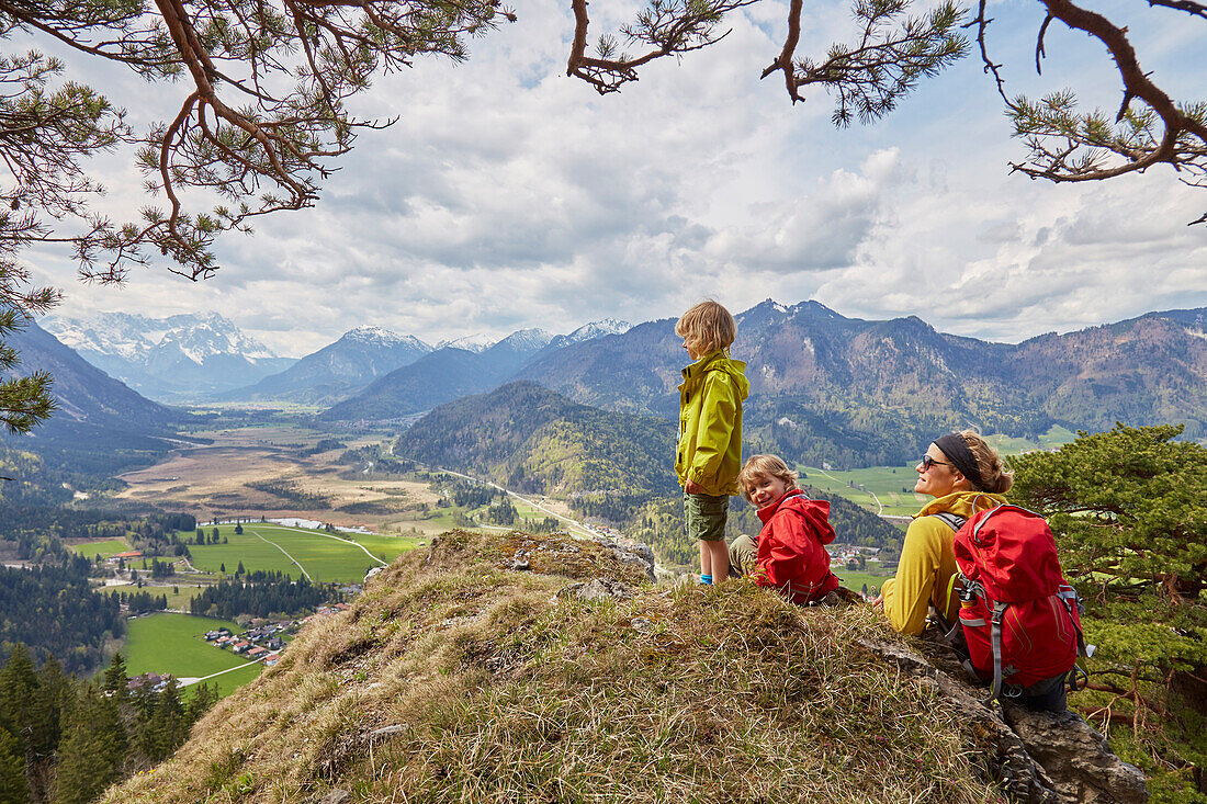 Familie schaut vom Berg ins Tal