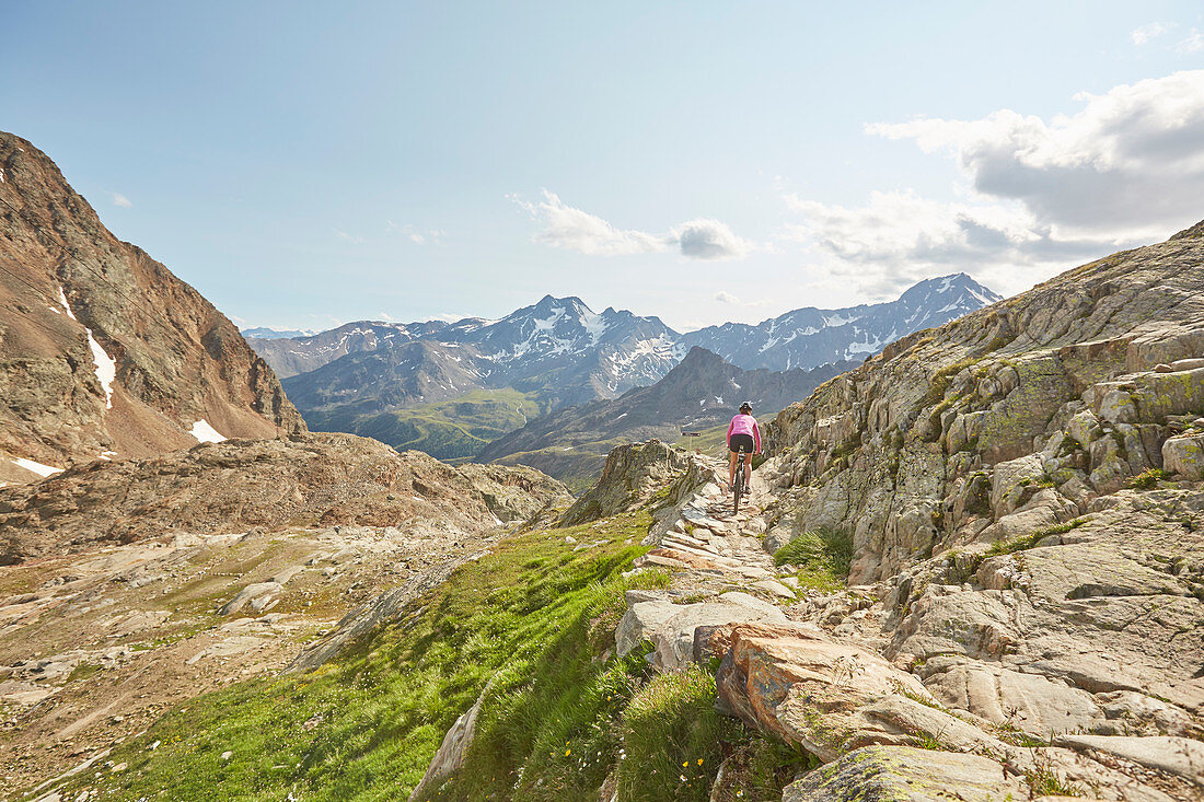 Woman riding down a trail on a mountainbike